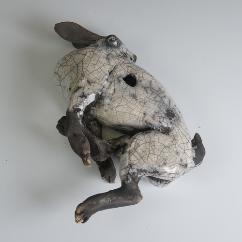 369 - Lawson E. Rudge (b. 1936), a raku fired studio pottery sculpture of a Hare, wall hanging, W 26cm.... 