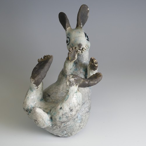 370 - Lawson E. Rudge (b. 1936), a raku fired studio pottery sculpture of a Hare, modelled on its back cur... 