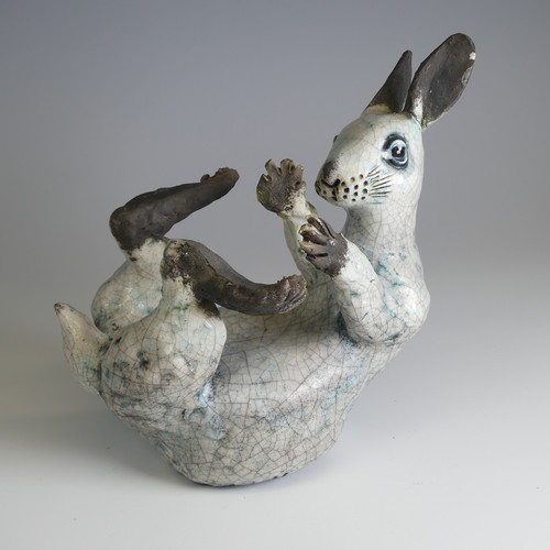 370 - Lawson E. Rudge (b. 1936), a raku fired studio pottery sculpture of a Hare, modelled on its back cur... 