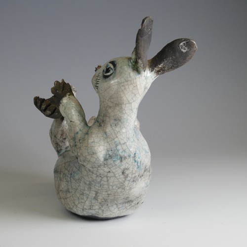 370 - Lawson E. Rudge (b. 1936), a raku fired studio pottery sculpture of a Hare, modelled on its back cur... 