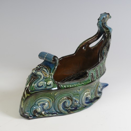 380 - A C. H. Brannam pottery boat shaped flower Trough, with mystical beast figurehead on scrolling waves... 