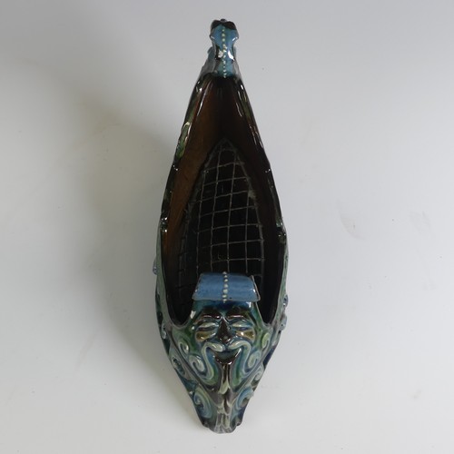 380 - A C. H. Brannam pottery boat shaped flower Trough, with mystical beast figurehead on scrolling waves... 