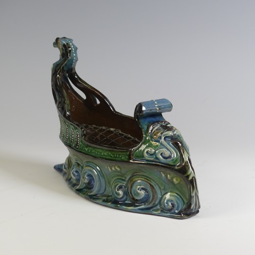 380 - A C. H. Brannam pottery boat shaped flower Trough, with mystical beast figurehead on scrolling waves... 