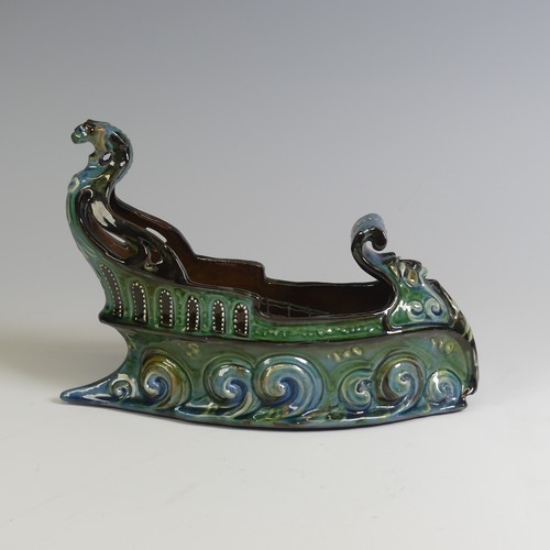 380 - A C. H. Brannam pottery boat shaped flower Trough, with mystical beast figurehead on scrolling waves... 