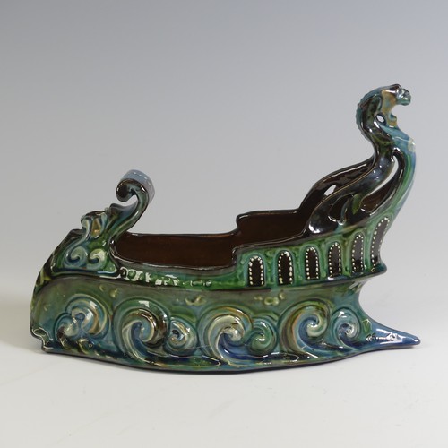 380 - A C. H. Brannam pottery boat shaped flower Trough, with mystical beast figurehead on scrolling waves... 