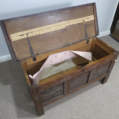 562 - An 18th century oak Coffer, with three carved panels to front and raised on square supports, W 120 c... 