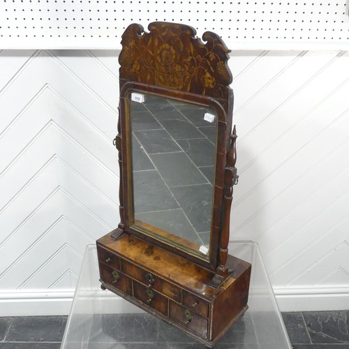 519 - A Queen Anne walnut Toilet Mirror, the carved and moulded pediment painted with stylised flowers and... 