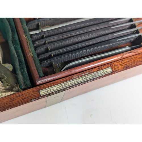 205 - A late 19th/early 20th century Arnold & Sons flame mahogany brass bound cased Field Surgeon's Ki... 