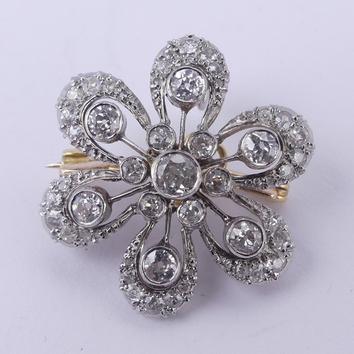  A diamond cluster foliate Pendant / Brooch, the central stone c. 0.25ct, with six smaller stones aro... 