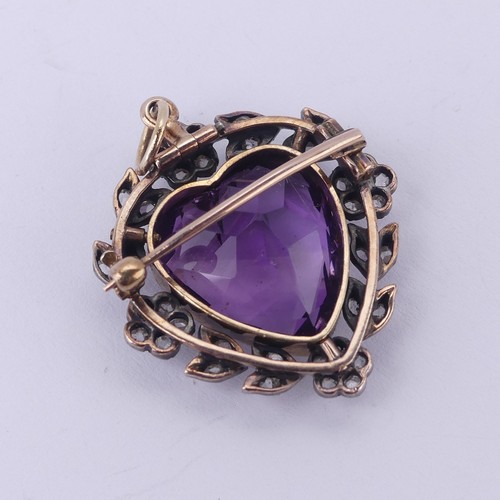  An Edwardian heart shaped Pendant / Brooch, in the Suffragette colours with central facetted heart s... 