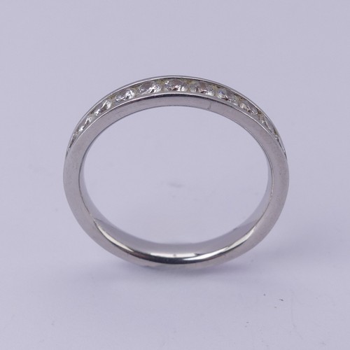  A diamond half hoop Eternity Ring, channel set with eleven brilliant cut stones, total diamond weigh... 