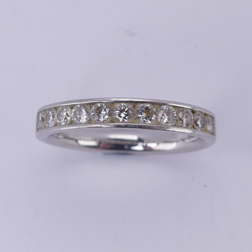  A diamond half hoop Eternity Ring, channel set with eleven brilliant cut stones, total diamond weigh... 