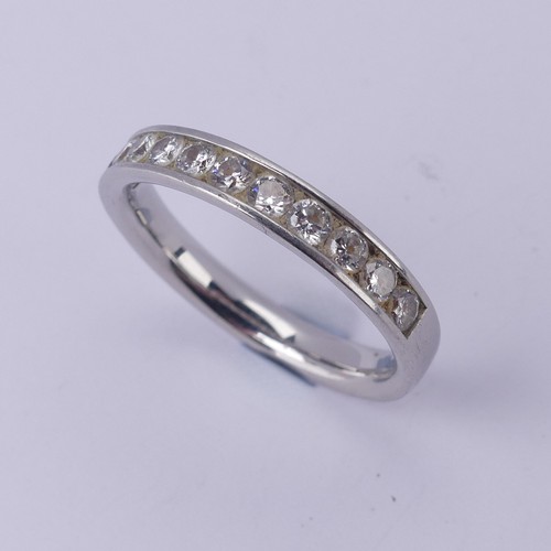  A diamond half hoop Eternity Ring, channel set with eleven brilliant cut stones, total diamond weigh... 