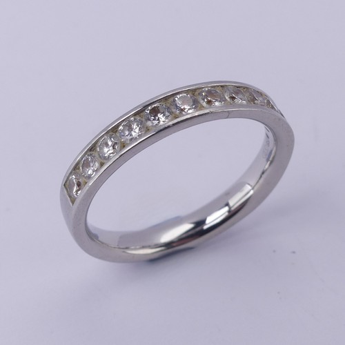  A diamond half hoop Eternity Ring, channel set with eleven brilliant cut stones, total diamond weigh... 