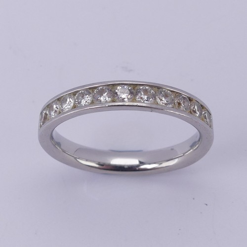  A diamond half hoop Eternity Ring, channel set with eleven brilliant cut stones, total diamond weigh... 