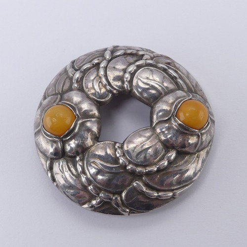 238 - Georg Jensen; A 90th Anniversary Brooch, model no. 42, set with two cabochon amber accents, inscribe... 