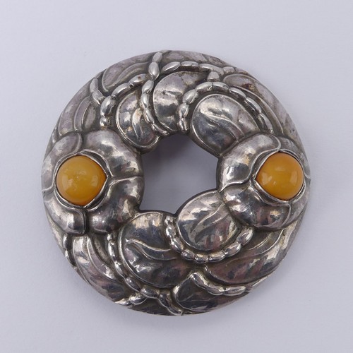 238 - Georg Jensen; A 90th Anniversary Brooch, model no. 42, set with two cabochon amber accents, inscribe... 