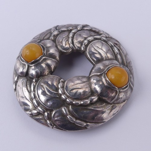 238 - Georg Jensen; A 90th Anniversary Brooch, model no. 42, set with two cabochon amber accents, inscribe... 