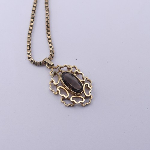 183 - An abstract 9ct yellow gold Pendant, the centre set with an oval facetted smoky quartz, 3cm long, on... 