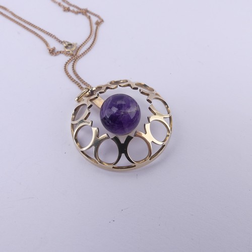 186 - A modernist amethyst 9ct gold Pendant, of open circular form with central cabochon amethyst, hallmar... 