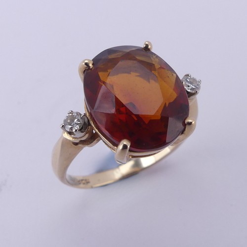 140 - A fire opal and diamond Ring, the central oval facetted stone approx. 12mm long, four claw set in 14... 