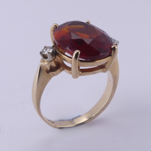 140 - A fire opal and diamond Ring, the central oval facetted stone approx. 12mm long, four claw set in 14... 