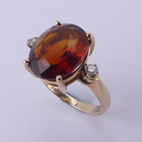 140 - A fire opal and diamond Ring, the central oval facetted stone approx. 12mm long, four claw set in 14... 