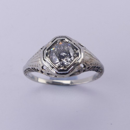 142 - A single stone diamond Ring, the circular stone approx. 0.7ct, difficult to size within the mount, i... 