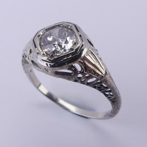 142 - A single stone diamond Ring, the circular stone approx. 0.7ct, difficult to size within the mount, i... 