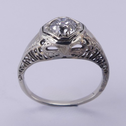 142 - A single stone diamond Ring, the circular stone approx. 0.7ct, difficult to size within the mount, i... 