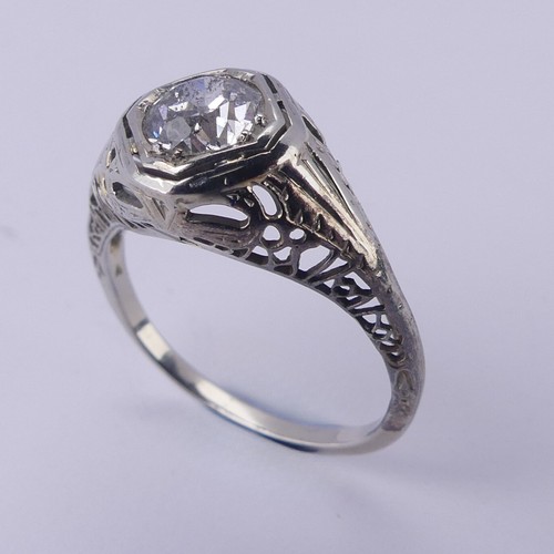 142 - A single stone diamond Ring, the circular stone approx. 0.7ct, difficult to size within the mount, i... 