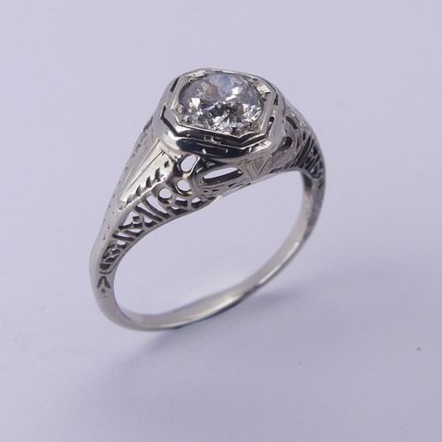 142 - A single stone diamond Ring, the circular stone approx. 0.7ct, difficult to size within the mount, i... 