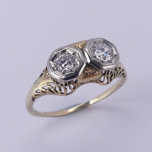 143 - A two stone diamond Ring, each circular stone approx. 0.2 ct, mounted in unmarked yellow and white g... 