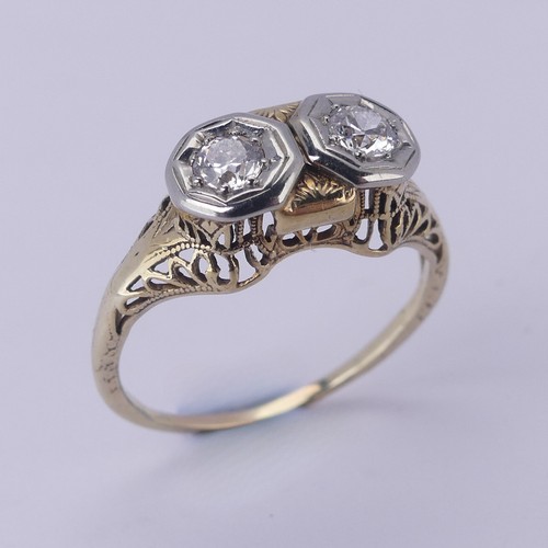 143 - A two stone diamond Ring, each circular stone approx. 0.2 ct, mounted in unmarked yellow and white g... 