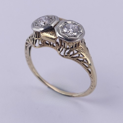 143 - A two stone diamond Ring, each circular stone approx. 0.2 ct, mounted in unmarked yellow and white g... 