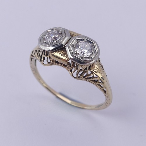 143 - A two stone diamond Ring, each circular stone approx. 0.2 ct, mounted in unmarked yellow and white g... 