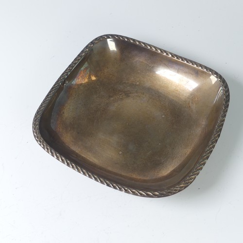 30 - A continental silver Bon Bon Dish, of square form with textured rim, raised on four cast supports, t... 