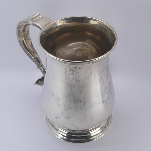 10 - A George II silver Mug, by John Kirkup, hallmarked Newcastle, 1755, of plain baluster form, the scro... 