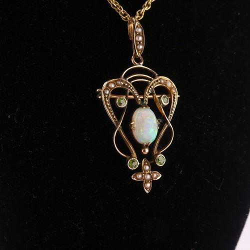 192 - An Art Nouveau opal Pendant, the central oval opal in scrolling open surround set demantoid garnets ... 