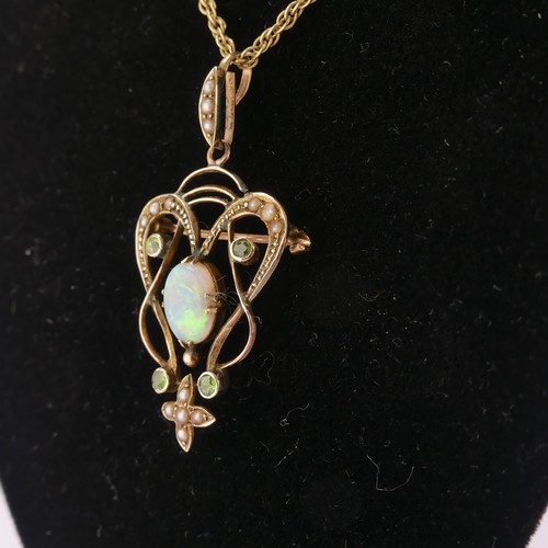 192 - An Art Nouveau opal Pendant, the central oval opal in scrolling open surround set demantoid garnets ... 