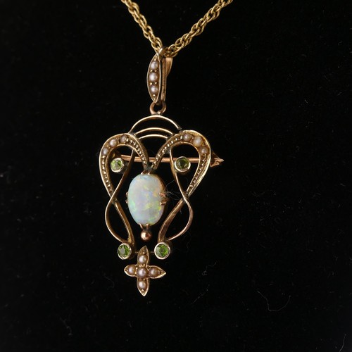 192 - An Art Nouveau opal Pendant, the central oval opal in scrolling open surround set demantoid garnets ... 