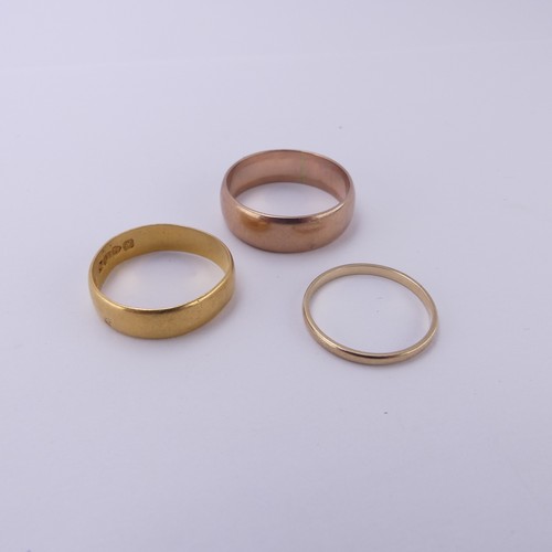 255 - A 22ct yellow gold Band, 5.4mm wide, Size Q, 3.6g, together with two 9ct gold bands; one narrow yell... 