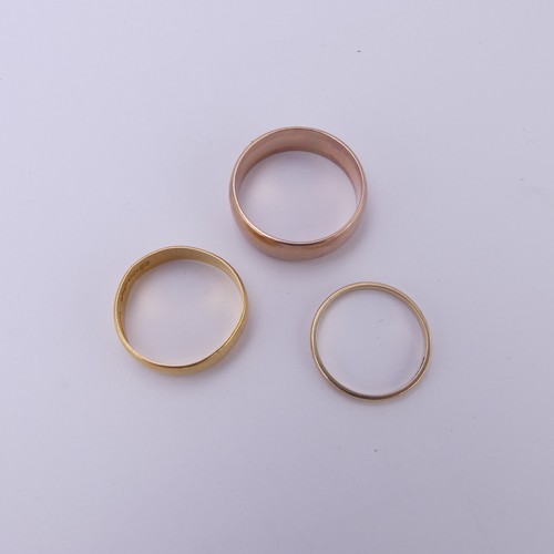 255 - A 22ct yellow gold Band, 5.4mm wide, Size Q, 3.6g, together with two 9ct gold bands; one narrow yell... 