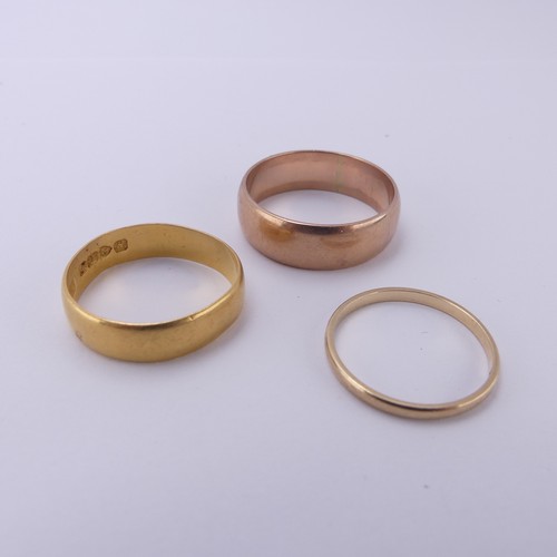 255 - A 22ct yellow gold Band, 5.4mm wide, Size Q, 3.6g, together with two 9ct gold bands; one narrow yell... 