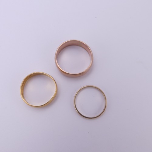 255 - A 22ct yellow gold Band, 5.4mm wide, Size Q, 3.6g, together with two 9ct gold bands; one narrow yell... 