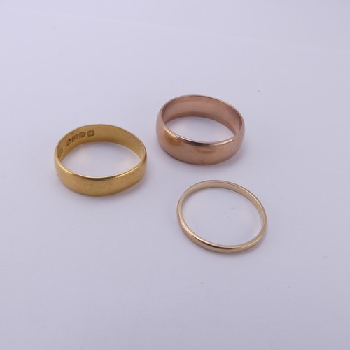 255 - A 22ct yellow gold Band, 5.4mm wide, Size Q, 3.6g, together with two 9ct gold bands; one narrow yell... 