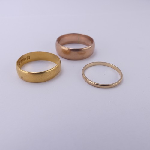 255 - A 22ct yellow gold Band, 5.4mm wide, Size Q, 3.6g, together with two 9ct gold bands; one narrow yell... 