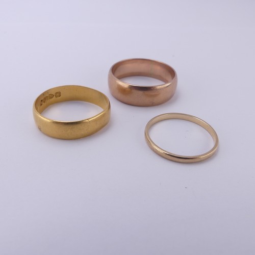 255 - A 22ct yellow gold Band, 5.4mm wide, Size Q, 3.6g, together with two 9ct gold bands; one narrow yell... 