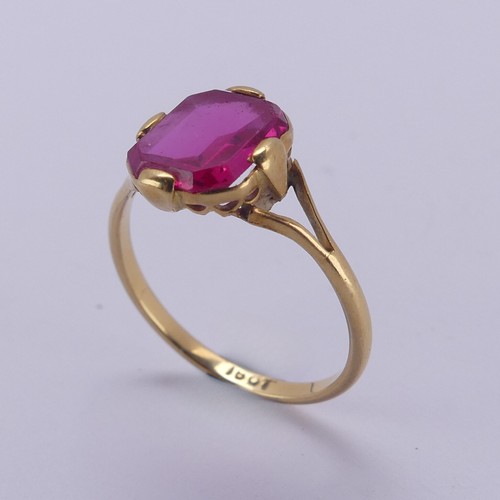 150 - A single stone pink sapphire Ring, the rectangular stone with canted corners, in four claw 18ct gold... 