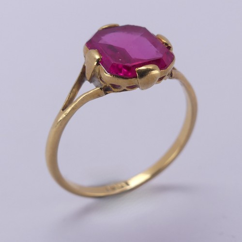 150 - A single stone pink sapphire Ring, the rectangular stone with canted corners, in four claw 18ct gold... 